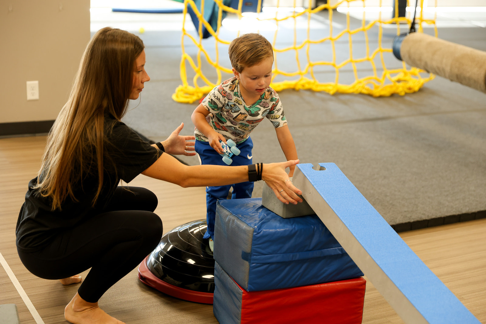 child and therapist doing DIRFloortime play therapy in Sioux Falls"