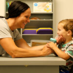 Speech therapist at Move U Sioux Falls working with a young child on feeding and oral motor skills in a calm play-based setting