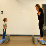 Child practicing balance during a play-based pediatric PT session at Move U in Sioux Falls SD